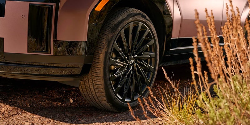 2026 Hyundai Santa Fe wheel and tire detail on outdoor terrain