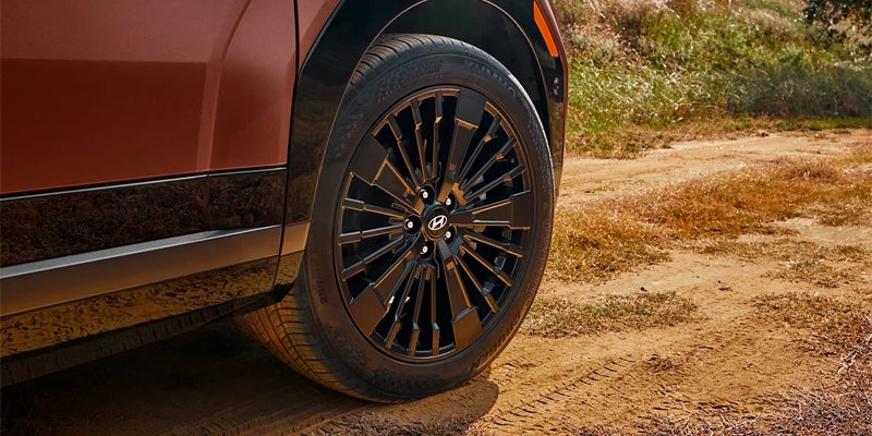 Hyundai Santa Fe Hybrid wheel and tire detail showcasing rugged exterior design.