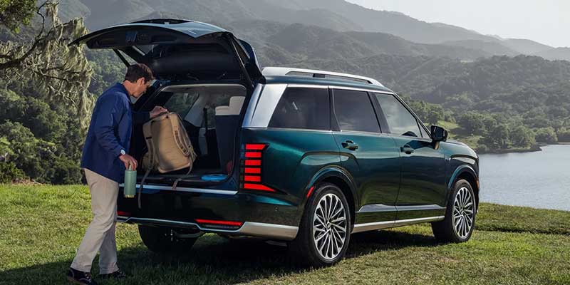 2026 Hyundai Palisade SUV cargo area with rear liftgate open outdoors