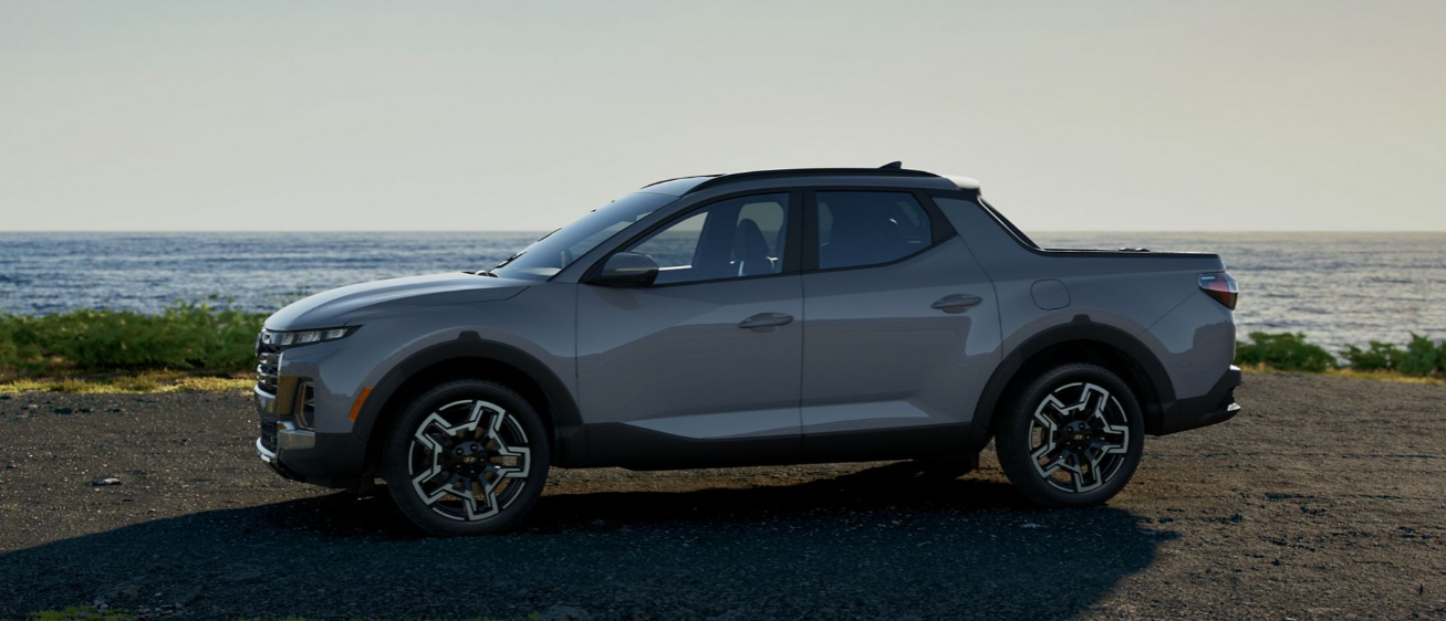 Gray 2026 Hyundai Santa Cruz pickup truck parked near the ocean.