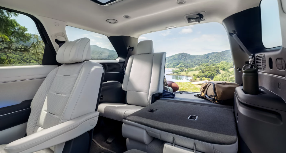 2026 Hyundai Palisade Hybrid third-row seating and cargo area with seats folded, highlighting spacious interior and versatility.