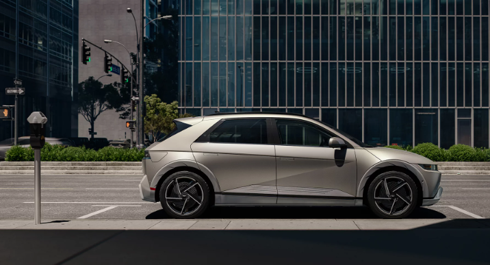 Beige 2026 Hyundai IONIQ 5 parked in city.